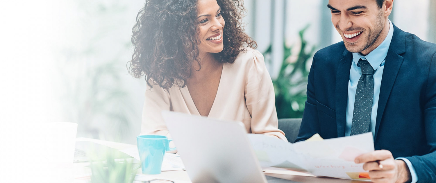 Man and woman reviewing papers at work